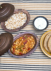 Turkish traditional meal, beans, rice, mixed pickles and tzatziki