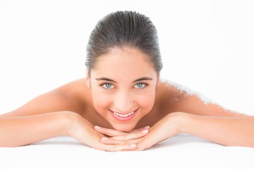 Obraz na płótnie Canvas Portrait of a beautiful brunette enjoying a salt scrub treatment