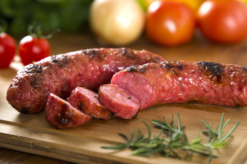 grilled meat sausages with potatoes and tomatoes