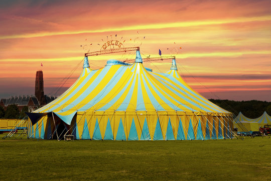 Circus tent under a warn sunset and chaotic sky