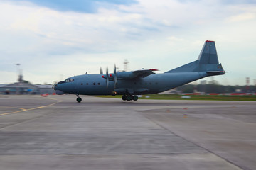 Fototapeta na wymiar Military transport aircraft an 12 quatrains of the runway at the front desk