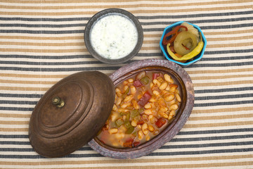Turkish traditional meal, beans, rice, mixed pickles and tzatziki