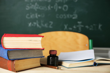 Teachers workplace  on blackboard background