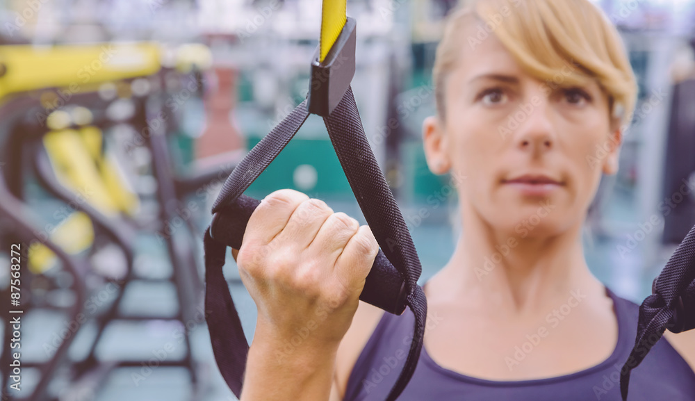 Wall mural Fitness strap in the hand of woman training