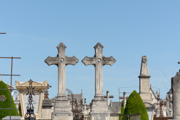 Two graveyard crosses side by side in cemetery in Bordeaux, France