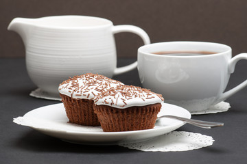 Cupcakes With Cocoa White Cream And Sprinkles. Coffee And Milk