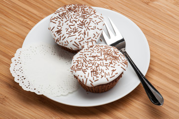 Cupcakes With Cocoa White Cream And Sprinkles