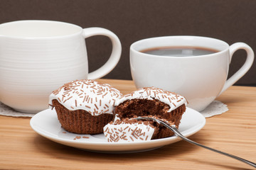 Cupcakes With Cocoa White Cream And Sprinkles. Coffee And Milk