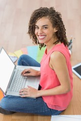 Young creative businesswoman working on laptop