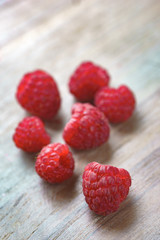 Raspberry on old vintage wooden table.