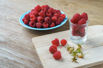 Raspberry on old vintage wooden table.