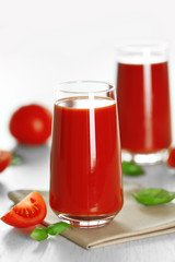 Fototapeta na wymiar Tomato juice and fresh tomatoes on wooden table close-up