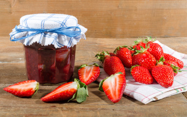Jam jar with fresh strawberries