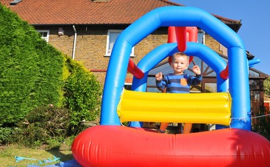 Child plays in a colorful bouncing castle