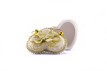 Heart shaped gift box decorated with gold rope isolated on white background
