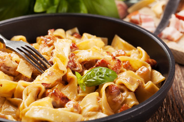 Pasta Carbonara with bacon, basil and cheese