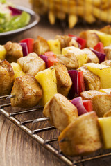 Grilled chicken skewers with pineapple, peppers and onions serve