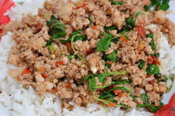 spicy stie fried pork chop with basil leaf and chili on rice