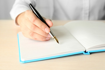 Businesswoman writing on document