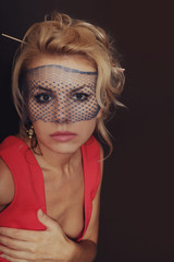 young blonde woman wearing a red dress and veil