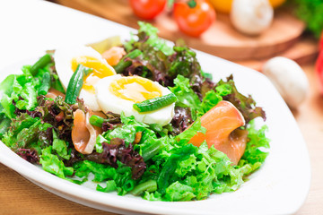 Fresh green salad with salmon and eggs