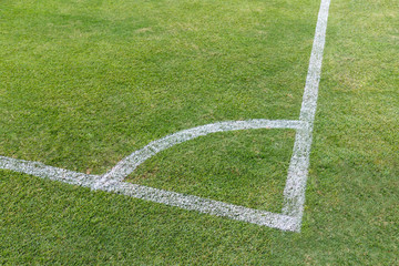 White stripe corner on the green soccer field from top view
