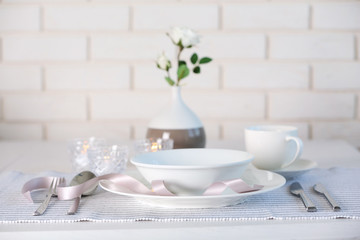Beautiful holiday table setting in white and gray color