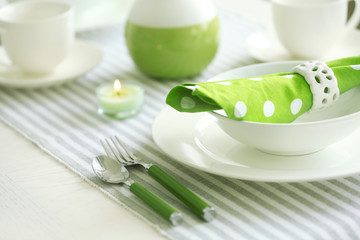 Beautiful holiday table setting in white and green color