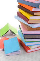 Heap of books on light background