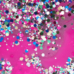 Abstract background of colorful glitters on the pink background