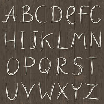 Decorative alphabet on wooden background, vector