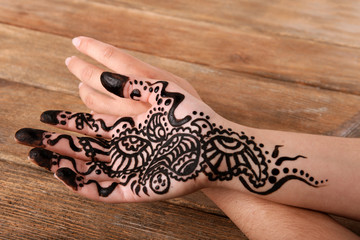 Hand painted with henna on wooden background
