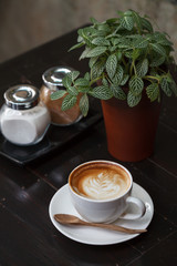 Cup of latte coffee on wooden table