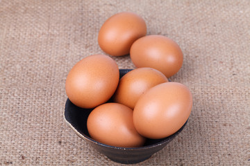 Eggs in a bowl on brown sack