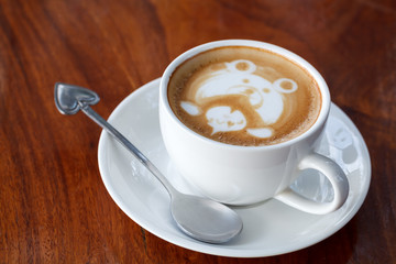 A cup of latte art coffee like face bear