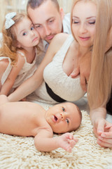 Obraz na płótnie Canvas Family portrait with newborn girl