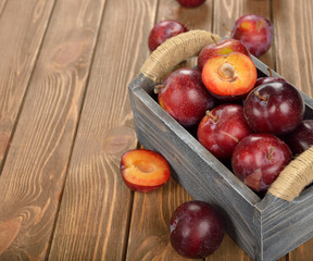 Fresh plums in a wooden box