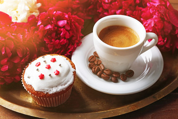 Composition with cup of coffee, muffins and peony flowers on tray, on wooden background