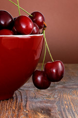 Cherries in bowl on wooden table