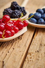 Currants and blueberries on a wooden table