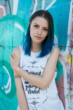 Young beautiful girl agains graffiti wall