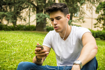 Young Man Listening to Music in Park