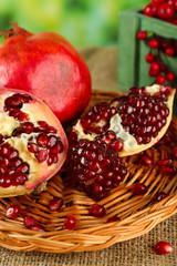 Pomegranate seeds on wicker tray, closeup