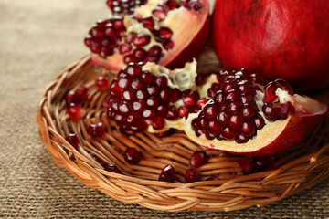 Pomegranate seeds on wicker tray, closeup