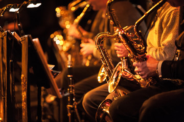 Big Band saxophone section. A candid view along the saxophone section of a big band in concert. - obrazy, fototapety, plakaty