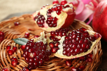 Pomegranate seeds on wicker tray, closeup