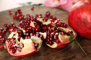 Pomegranate seeds on wooden table, closeup