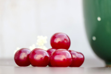 Red cherry and green cup