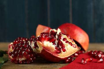 Pomegranate seeds on wooden table, closeup