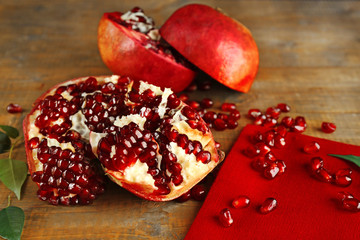 Pomegranate seeds on wooden table, closeup